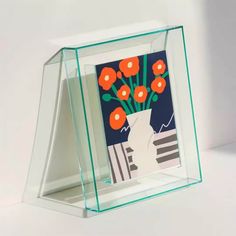 an art piece with orange flowers in a glass frame