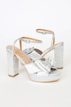 The Lulus Lilsa Silver Metallic Bow Platform Ankle Strap Heels are here to bring a perfect party look! Crinkle textured metallic fabric shapes these glam heels that have an open toe and crisscrossing straps that tie together at a large bow. A matching strap wraps around and secures above the ankle with a silver buckle. Trendy 0.75"" toe platform. Block heel. 4. 25" wrapped block heel. Cushioned insole. Felted rubber sole has nonskid markings. All Man Made Materials. Imported. Lulus | Lilsa Silve Platform Ankle Strap Heels, Glam Heels, Silver Metallic Heels, Twisted Ankle, Trendy High Heels, Cute High Heels, Heels Prom, White High Heels, Designer High Heels