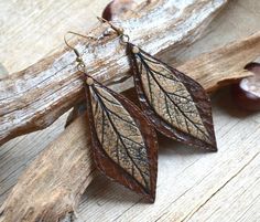 Chestnut brown and bronze nature inspired earrings are made of polymer clay using the rich leather texture and the real leaf imprint. They definitely will not allow its owner to remain unnoticed. The earrings are made in warm earth tones that remind us about autumn fall. The earrings are large, but Leaf-shaped Brown Earrings Gift, Brown Leaf-shaped Earrings For Gift, Brown Leaf-shaped Earrings Gift, Brown Leaf-shaped Jewelry For Gift, Brown Patina Jewelry For Gifts, Handmade Brown Leaf-shaped Jewelry, Bohemian Brown Leaf-shaped Earrings, Brown Patina Jewelry Gift, Handmade Brown Nature-inspired Earrings