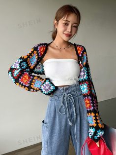 a young woman is posing for the camera wearing jeans and a cropped white top