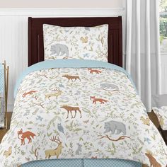 a bed with animals on it in a room next to a window and white curtains