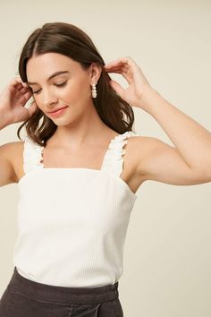 ruffle knit tank top Elegant Ribbed Tank Top For Summer, Elegant Ribbed Summer Tank Top, White Feminine Tank Top With Ruffled Straps, Trendy White Ruffled Tank Top, White Feminine Camisole With Ruffles, White Feminine Ruffled Camisole, Ruffled Tank Top With Tank Straps For Spring, White Fitted Tank Top With Ruffled Straps, Feminine Camisole With Ruffled Straps For Day Out