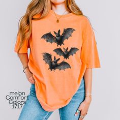 Flying Bats Shirt, Comfort Colors T-shirt, Flying Bat Graphic Tee, Gift for Halloween Season, Trick-or-Treat Shirt, Urban Life T-shirt, Printed front and back. Back has only one bat, front view has 3 bats. About Comfort Colors 1717 ------------------------------------- Comfort Colors 1717 adult unisex short sleeve heavyweight t-shirt is garment-dyed and soft-washed for a comfortable vintage look and feel. The soft-washed, garment-dyed fabric brings extra coziness to your wardrobe while the relaxed fit makes it an excellent daily choice. The double-needle stitching throughout the tee makes it highly durable while the lack of side-seams helps the shirt retain its tubular shape. ✨ 100% ring-spun cotton ✨ Preshrunk, Soft-washed, Garment-dyed fabric ✨ Without side seams, Double needle stitching Casual Orange Tops For Halloween, Halloween Orange Graphic Print T-shirt, Spooky Orange Crew Neck Top, Spooky Orange Graphic Print T-shirt, Orange Halloween Graphic T-shirt, Orange Crew Neck Top For Halloween, Funny Orange Tops For Fall, Funny Orange Top For Fall, Orange Cotton Tops For Halloween