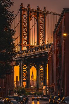 cars are parked in front of the bridge