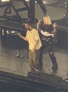 a man and woman on stage with microphones