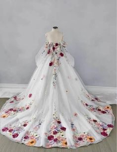 a white wedding dress with flowers on it