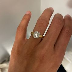 a woman's hand with a diamond ring on it