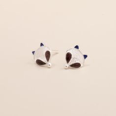 Discover the perfect blend of traditional craftsmanship and whimsical charm with our Fox Cloisonné Enamel Stud Earrings. These unique studs showcase the intricate beauty of Chinese Cloisonné artistry on a luxurious S999 silver base. Key Features: - Exquisite Cloisonné Technique: Each earring features vibrant enamel work, bringing the playful fox design to life. - Premium S999 Silver Base: Crafted with high-purity silver for lasting quality and shine. - Filigree Artistry: Delicate filigree detail Adjustable Animal Design Earrings As Gift, Silver Animal Design Jewelry For Gifts, Silver Jewelry With Animal Design For Gift, Whimsical Hand Painted Silver Earrings, Hand Painted Sterling Silver Earrings For Gift, Traditional Hypoallergenic Earrings As Gift, Traditional Hand Painted Sterling Silver Jewelry, Unique Studs, Fox Face