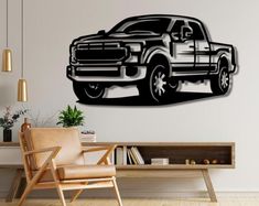 a black and white truck is on the wall above a chair in a living room