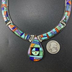 "ALVIN YELLOWHORSE NECKLACE DESCRIPTION: Top-tier Navajo silversmith Alvin Yellowhorse has opened his crayon box of gemstones and created a colorful work of wearable art. Micro inlay of turquoise, sugilite, variscite, lapis, orange spiny oyster shell, jet, and denim lapis set in heavy gauge sterling silver. This extraordinary necklace will be a cherished addition to your collection of the very finest Native American jewelry. MEASUREMENTS: Necklace measures 16\" Pendant measures 1 7/8\" x 1 1/8\" Multicolor Inlay Southwestern Necklace, Multicolor Round Collectible Jewelry, Southwestern Multicolor Multi-stone Necklace, Unique Multicolor Inlay Necklaces, Unique Multicolor Inlay Necklace, Multicolor Round Necklace For Collectors, Multicolor Round Inlay Necklaces, Jewelry Measurements, Crayon Box