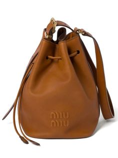 Miu Miu logo-embossed Leather Bucket Bag - Farfetch Miu Miu Brown Shoulder Bag With Detachable Strap, Miu Miu Brown Bag With Detachable Strap, Brown Miu Miu Shoulder Bag With Detachable Strap, Elegant Brown Miu Miu Shoulder Bag, Miu Miu Formal Bags With Adjustable Strap, Miu Miu Formal Bag With Adjustable Strap, Formal Miu Miu Shoulder Bag With Adjustable Strap, Formal Miu Miu Bags With Adjustable Strap, Brown Leather Miu Miu Shoulder Bag