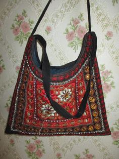 "Pretty shoulder\\handbag made of soft velour. The back is plain black, the front is embroidered and beaded in reds and golds. There are no pockets inside, it has a zip top. A perfect evening bag. Width;  10\" Height;  11\" Strap;  20\" Made in France cotton mix" Vintage Black Shoulder Bag For Festival, Festival Red Shoulder Bag With Handwork, Vintage Shoulder Bag For Everyday And Festivals, Red Shoulder Bag With Handwork For Festivals, Red Handwork Shoulder Bag For Festivals, Traditional Red Beaded Bags, Bohemian Embellished Tote Shoulder Bag, Vintage Embroidered Bags For Festivals, Vintage Embroidered Shoulder Bag