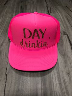 "Day Drinkin' Trucker Hat 100% Polyester Foam Front, Soft Mesh Back, Structured, Mid-profile, 3.5\" Crown, Five-panel with braid, Plastic Tab Closure. One Size. Please let us know if the note section what color print you would like on your hat. We have almost every color glitter and regular vinyl as well as gold and silver foil. The color you select in the drop down menu is the color of the hat. If you do not leave a note for the print color choice, we will select the default color for you. All Fun Snapback Baseball Cap For Parties, Fun Party Snapback Baseball Cap, Novelty Snapback Trucker Hat For Party, Pink Trucker Hat For Party With Curved Brim, Novelty Snapback Party Hats, Novelty Trucker Hat For Party, Party Snapback Hat With Curved Brim, Adjustable Flat Brim Trucker Hat For Party, Adjustable Curved Brim Snapback Hat For Party