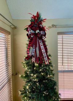 a decorated christmas tree in the corner of a room