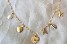 18K Gold Plate Beach Inspired Tarnish Resistant Charm Necklace Stainless steel Beach Summer Necklace Heart Initial Shell Starfish Necklace  The Chain is 18k Gold Plate Stainless Steel and Tarnish Resistant.  All of the Charms are 18K Gold Plate Tarnish Resistant   A Gorgeous Beach/Summer Inspired Necklace Please choose your Initial from the drop down menu  *J is not available at the moment*  It measures 18 inches long, but can be made longer, please choose your length from the drop down menu 🌛 More designs coming All jewelry is gift wrapped 💗 Please read shipping info below prior to purchasing thank you 💗 All Orders now have tracking and Insurance Once your order is dispatched, you can click on the tracking number sent in your dispatch notice and track your parcel Please visit our other Gold Charm Necklace For Vacation, Gold Charm Necklaces For Vacation, Starfish Necklace, Inspired Necklace, Necklace Heart, Summer Necklace, Beach Inspired, Beach Summer, Heart Necklace