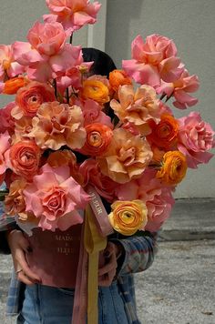 a person holding a bouquet of flowers on their head