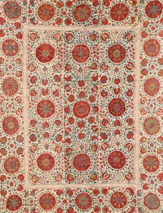 an antique rug with red and green designs