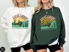 This unisex Great Smoky Mountains National Park Sweatshirt is made of cotton and polyester and is the perfect shirt to wear on a family vacation, camping or hiking trip to the Blue Ridge Mountains.  The collar is ribbed knit, so it retains its shape even after washing. Side seams are constructed to ensure they are smooth and there is no itching.  This Tennessee National Park sweatshirt features green trees and a grazing Deer in front of a vibrant yellow sun. The Great Smoky Mountains name is in Desert Bachelorette, Bachelorette Merch, Luxury Bachelorette, Scottsdale Bachelorette, Club Sweatshirts, Bachelorette Shirts, Cow Girl, Bridal Party Gifts, Social Club