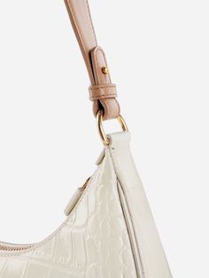 The Carrie Shoulder Bag features a gentle half-moon shape and slim, structured silhouette, offering a vintage-inspired look. The signature belt loop detail allows for the strap to be lengthened, making it perfect to carry on hand or use the shoulder strap for a hands-free style. Classic Handheld Baguette Bag With Adjustable Strap, Classic Beige Baguette Bag With Detachable Handle, Classic Everyday Baguette Bag With Adjustable Handle, Classic Formal Baguette Bag With Adjustable Handle, Chic Baguette Hobo Bag With Adjustable Strap, Chic Baguette Bag With Adjustable Handle, Baguette Hobo Bag With Adjustable Strap, Classic Baguette Bag With Adjustable Strap, Classic Beige Handheld Baguette Bag