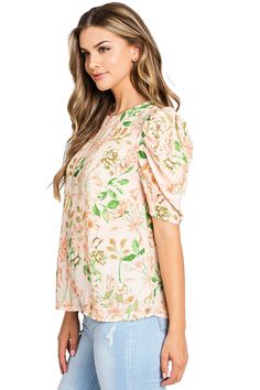 Light, chiffon blouse with a whimsical, floral print. Round neckline with a relax fit and a puff shoulder, short sleeve. Chic and effortless top, looks great paired with denim. CARE | Dry Clean or Hand Wash Cold CONTENTS | 100% Polyester MEASUREMENTS | 25"/63 cm Shoulder to Hem (Size Small) MODEL | 5'8 - wearing a size Small IMPORTED Casual Floral Print Short Sleeve Top For Summer, Spring Puff Sleeve Top With Balloon Sleeves, Spring Floral Print Tops With Flutter Sleeve, Trendy Spring Puff Sleeve Top With Floral Print, Trendy Puff Sleeve Top With Relaxed Fit For Spring, Floral Print Balloon Sleeve Tops For Day Out, Trendy Relaxed Fit Puff Sleeve Top For Spring, Spring Floral Print Puff Sleeve Top, Spring Feminine Puff Sleeve Top With Short Sleeves