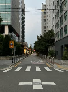 an empty city street with buildings in the background