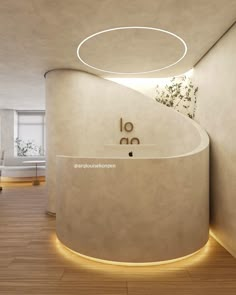 the interior of an office with curved walls and wood flooring is lit by recessed lighting