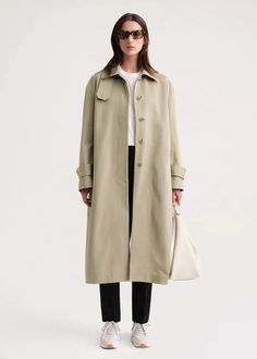 Elevate your outerwear with the Signature trench khaki. Crafted from durable cotton, this long coat exudes a vintage classic vibe. With a stand collar and long version, stay warm and stylish in any weather. A must-have for fashion-forward individuals. Khaki Gabardine Long Coat, Classic Olive Outerwear For Spring, Long Khaki Outerwear For Work, Khaki Long Raincoat For Spring, Cotton Raincoat For Workwear In Fall, Fall Cotton Raincoat For Workwear, Fall Cotton Raincoat For Work, Wind Coat, Trench Beige