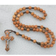 Olive wood rosary beads and crucifix mounted on a cord. Round bead size 6. Length: 13" Brown Cross-shaped Rosary With Wooden Beads, Brown Wooden Beaded Cross Rosary, Adjustable Brown Wooden Beads Rosary, Brown Rosary With 8mm Beads And Cross Shape, Adjustable Brown Wooden Bead Rosary, Brown Rosary With 8mm Beads, Adjustable Brown Wooden Rosary, White Gold Engagement Rings Vintage, Rosary Jewelry