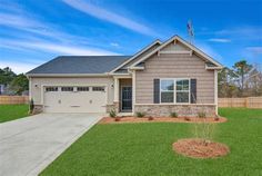 a house with a driveway in front of it and grass on the ground next to it