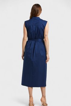 This Lauren Navy Blue Ruffled Shirt Dress is a versatile and stylish addition to any wardrobe. Made in Italy from a luxurious cotton blend, it features a banded neckline, button-down front, and beautiful ruffled trim along one side. The coordinating color belt accentuates your figure while the side inseam pockets add functionality. With a sleeveless design, full skirt, and back yoke with pleats, this dress falls just below the knee for a flattering and elegant look. Make a lasting impression in Ruffled Shirt, Ruffle Shirt, Coordinating Colors, Full Skirt, Fall Dresses, Summer Collection, Effortless Style, The Knee, Clothing Store