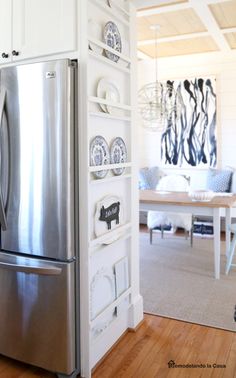 a stainless steel refrigerator sitting inside of a kitchen