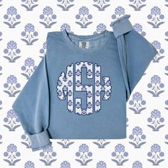 Perfect for chilly beachy nights or to look cute while being casual, this Preppy Blue Monogrammed sweatshirt will be a favorite for years to come! It also makes the best bridesmaid gift or for the "coastal grandmother" in your life. The floral block print is loved by many! This custom crewneck sweatshirt brings both incredible quality and amazing style to the mix. Made with soft, ring-spun cotton fabric with 100% cotton threads, it sits unmatched when it comes to softness. All sweatshirts featur Casual Monogram Print Sweater For Fall, Casual Monogram Print Sweatshirt For Winter, Blue Sweater With Graphic Print For Loungewear, Blue Graphic Print Sweater For Loungewear, Cotton Long Sleeve Tops With Monogram Print, Cotton Monogram Print Top For Fall, Blue Long Sleeve Soft-washed Sweatshirt, Casual Long Sleeve Sweatshirt With Monogram Print, Casual Long Sleeve Monogram Sweatshirt