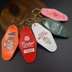 four different colored plastic keychains sitting on top of a table