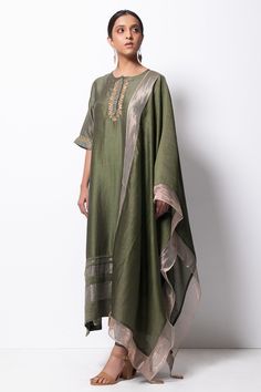 Olive green handwoven kurta with zardozi floral motif embroidered placket and sleeves. Paired with cotton silk pant and stole with tassels. Comes with slip.
Component: 4
Pattern: Embroidered
Type Of Work: Floral Motifs
Neckline: Round
Sleeve Type: Three Quarter
Fabric: Kurta: Handwoven Chanderi Silk; Stole: Chanderi; Pant: Cotton Silk
Color: Green
Other Details: 
Front concealed placket
Side slit kurta
Kasab thread zari tassels
Side pocketed kurta
Occasion: Puja - Aza Fashions Silk Kurta Set, Simple Dress Casual, Silk Kurti Designs, Silk Stoles, Silk Pant, Kurti Embroidery Design, Silk Kurta, Kurta Designs Women, Pant Set For Women