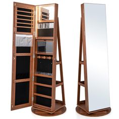 a large mirror sitting on top of a wooden stand next to a shelf filled with drawers