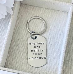 there is a keychain that says, brothers are better than superheros