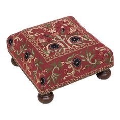 a red and green ottoman with wooden legs