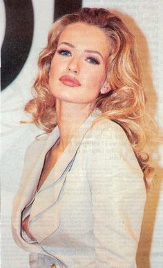 a woman with blonde hair and blue eyes posing for a magazine advertiser's photo