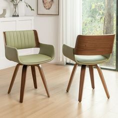 two chairs sitting on top of a hard wood floor next to a white wall and window