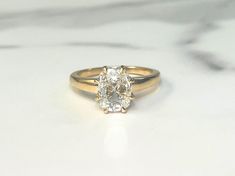 a diamond ring sitting on top of a marble counter