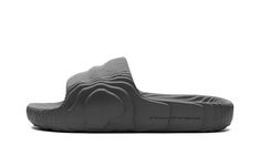 The adidas Adilette Slide 22 “Grey” is a colorway of the comfortable slip-on sandal that’s made from sustainably sourced materials.  Reminiscent of the adidas Yeezy Slide, the Adilette 22 has a contemporary vibe with wavy lines inspired by 3D topography.  The sandal  is made from lightweight EVA foam that contains up to 25% plant-based ingredients derived from sugarcane.  The “Grey” colorway features a monochromatic grey appearance with “The Brand With the Three Stripes” branding on the lateral Adidas Adilette 22, Stripes Branding, Adidas Yeezy Slide, Yeezy Slides, Spaghetti Strap Bodycon Dress, Plus Size Bodycon Dresses, Wavy Lines, Adidas Adilette, Boho Floral Dress