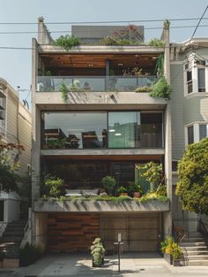 an apartment building with plants growing on the balconies