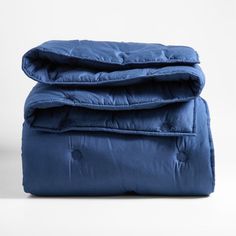 the blue comforter is folded on top of it