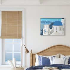 a bedroom with white walls and blue domes on the roof, along with an ocean view