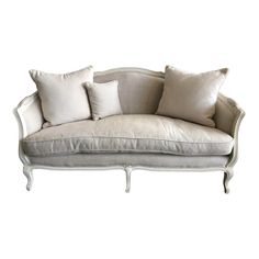 a white couch with four pillows on it