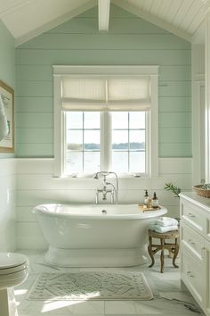 a white bath tub sitting next to a window in a bathroom