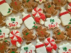 gingerbread cookies decorated with candy canes and candies are displayed on a table