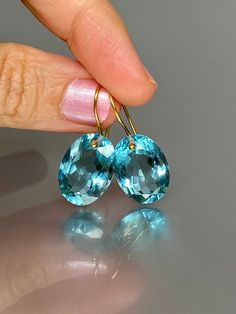 Gorgeous sparkly sky blue aquamarine earrings. The Faceted oval drops are flawless and have a beautiful sky blue color. The drops are attached to 14K18K SOLID GOLD ear wires. The earrings are elegant and have a lux look.  A truly gorgeous pair of earrings.  14K SOLID GOLD ear wires are being used, the ear wire ends are hand-stamped as proof of being 14K solid gold. In addition, extra work was done at the end of the ear wires to prevent any sort of pain or injury while inserting them through the ear lobes. **The 14K WHITE solid gold ear wires are RHODIUM plated to prevent tarnish of the ear wires over time. * Quality: Superb AAA+ FlawlessAquamarine * Carat (26 ct.) * Stone Shape: Facet Oval Shape * The dimension of stones: 18mm X 13mm / 0.7X 0.5 inch  * Metal: 24K Gold Vermeil/ 14K SOLID GO Luxury Blue Aquamarine Earrings, Luxury Aquamarine Blue Earrings, Oval Aquamarine Light Blue Jewelry, Oval Light Blue Aquamarine Jewelry, Light Blue Oval Aquamarine Jewelry, Faceted Yellow Gold Oval Earrings, Yellow Gold Faceted Oval Earrings, Luxury Oval Blue Topaz Earrings, Fine Jewelry Blue Aquamarine Earrings