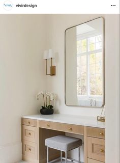 a bathroom with a vanity, stool and mirror