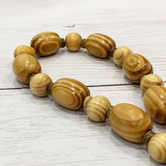 Wooden Bead Necklace, Chunky Wood Necklace, Unisex Beaded Necklace, Light Wood Beaded Necklace, Mens Necklace Wood, Women's Wood Necklace This unique wood necklace was hand beaded using a mix of large 28mm round barrel shaped light colored wood beads, 14mm round wood beads, and 3mm wood rondelles in an easy, modern design. The necklace measures approximately 26 inches long and is securely fastened with a silver clasp. Perfect for any gender! Pairs well with any casual outfit! Length can be adjus Large Oval Bead Necklace For Beach, Beach Beaded Necklace With Large Oval Beads, Beach Necklace With Polished Oval Beads, Beach Necklace With Large Oval Beads, Oval Beach Necklace With Large Beads, Beach Oval Beaded Polished Necklace, Beach Wooden Beaded Necklaces With Oval Beads, Beach-style Oval Wooden Beaded Necklaces, Vintage Wooden Bead Necklaces For Beach